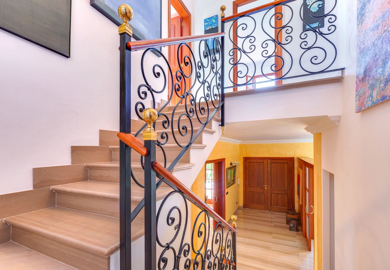  Staircase with landings and a cast iron railing.