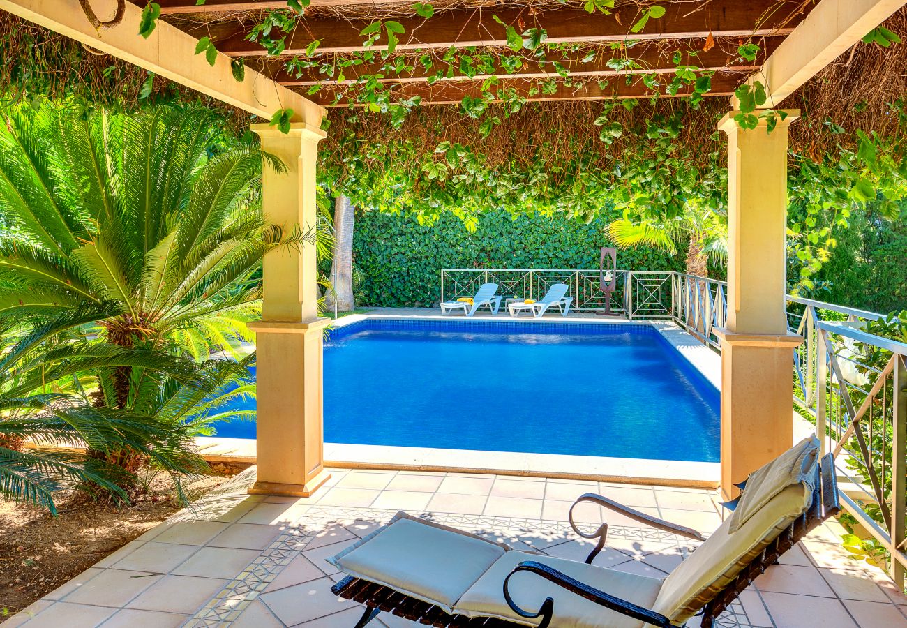 Fenced pool with a shaded area.