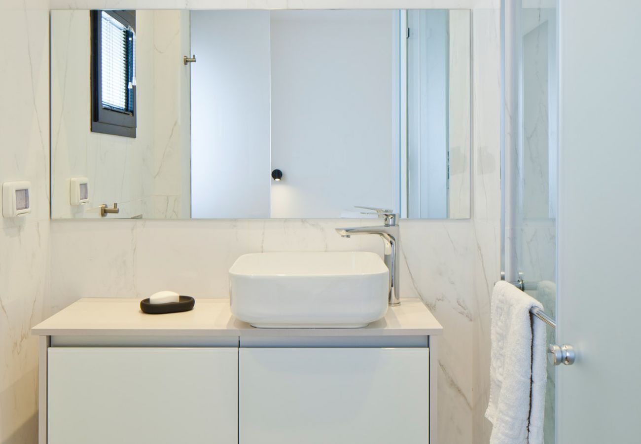 Bright and modern bathroom with a sink and a mirror in apartment on Ben Yehuda st.