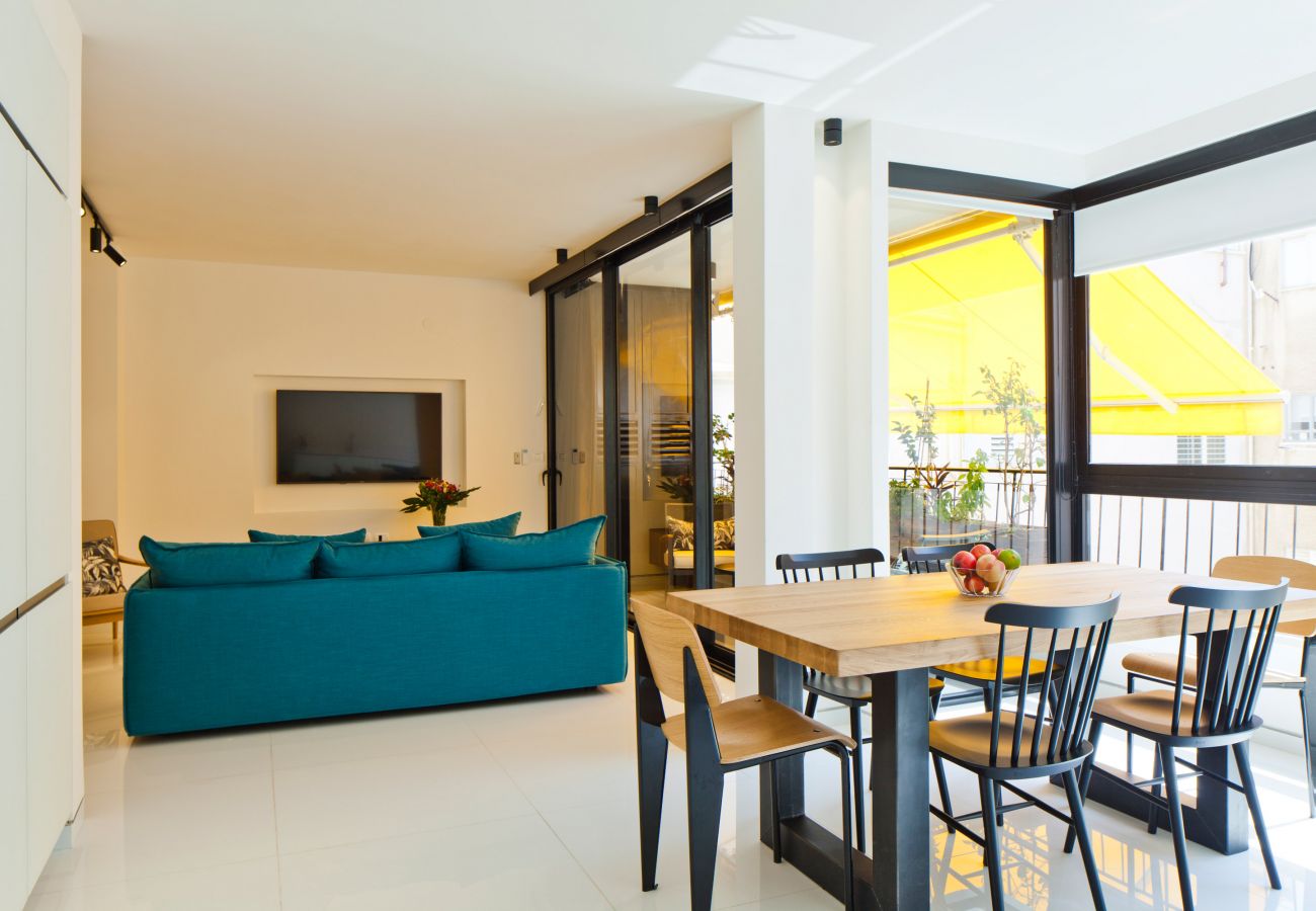 Dining area with a beautiful table and chairs in apartment on Ben Yehuda st.