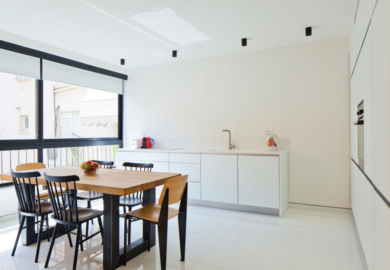 Bright and modern kitchen with a table in apartment on Ben Yehuda st.