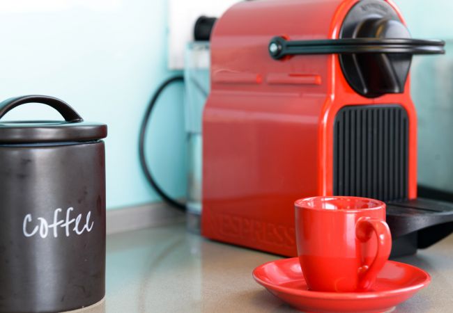 Efficient Nespresso machine in the red colour at the apartment on Ben Yehuda st.