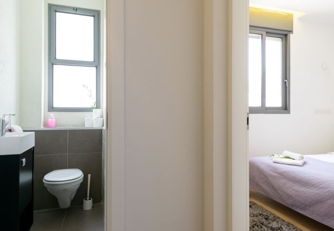 View of the modern bathroom and bright bedroom on Ben Yehuda st.