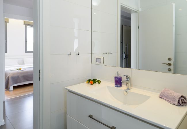 Modern white sink with big mirror on Ben Yehuda st. 