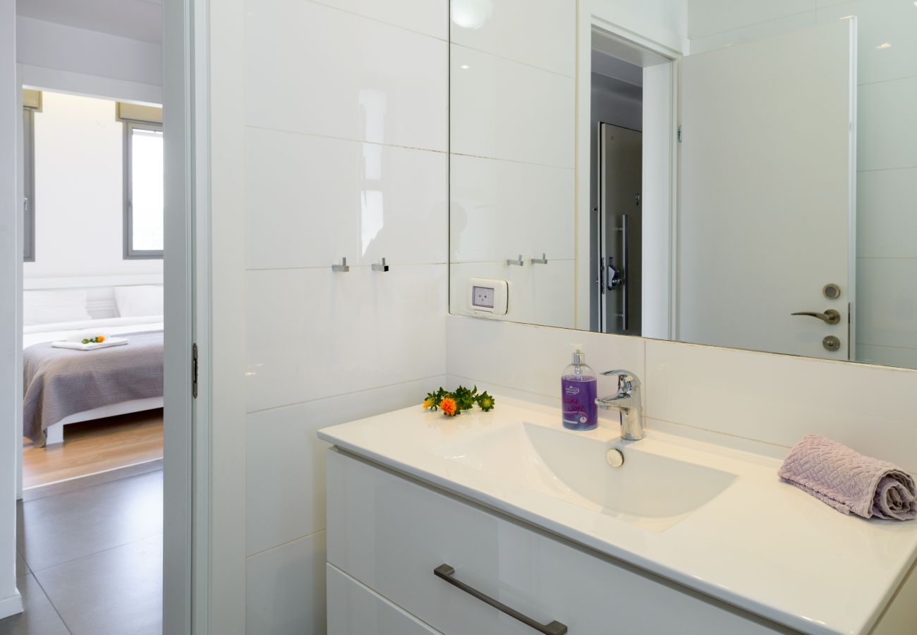 Modern white sink with big mirror on Ben Yehuda st. 