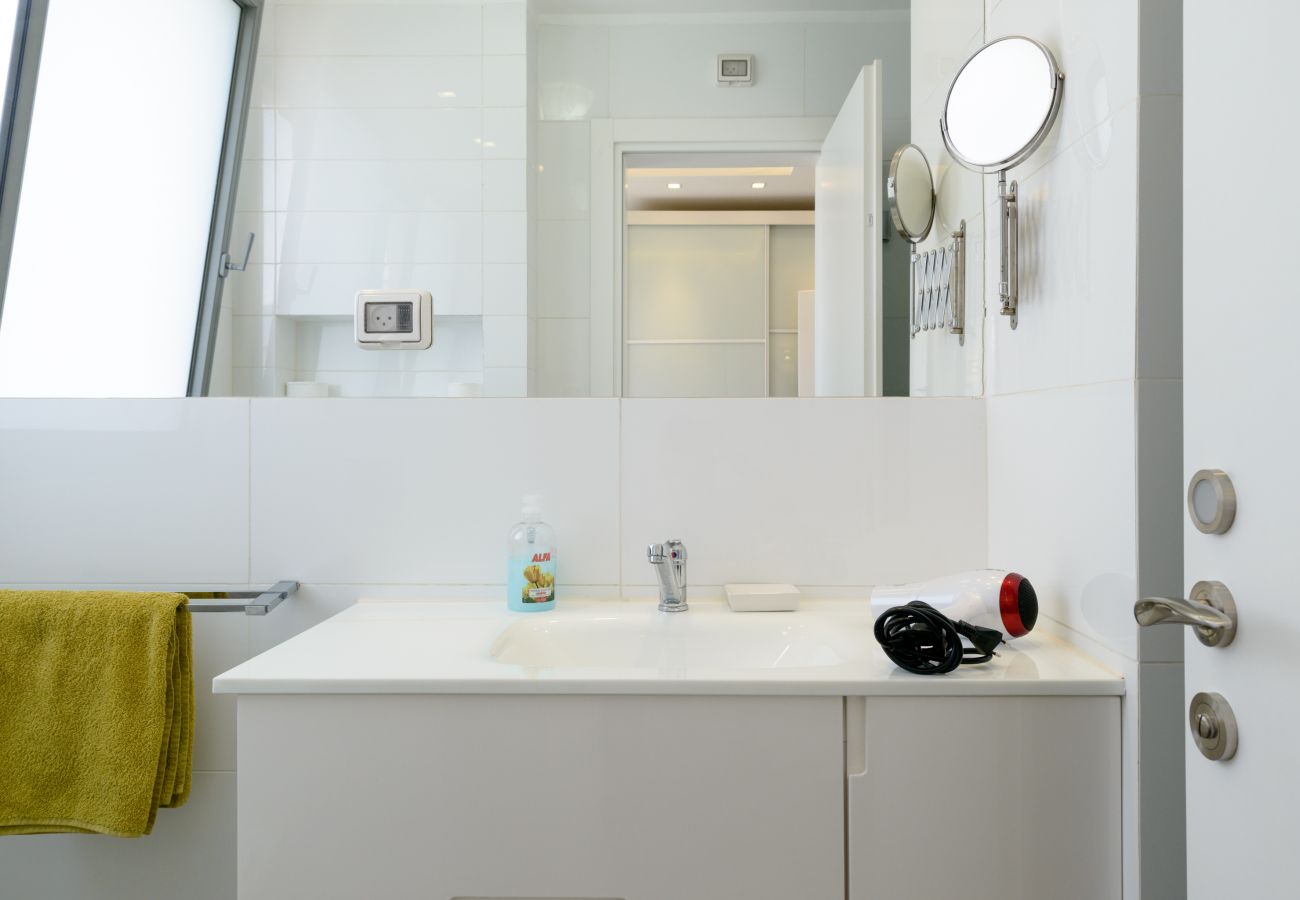 Clean white sink with a big mirror on Ben Yehuda st. 