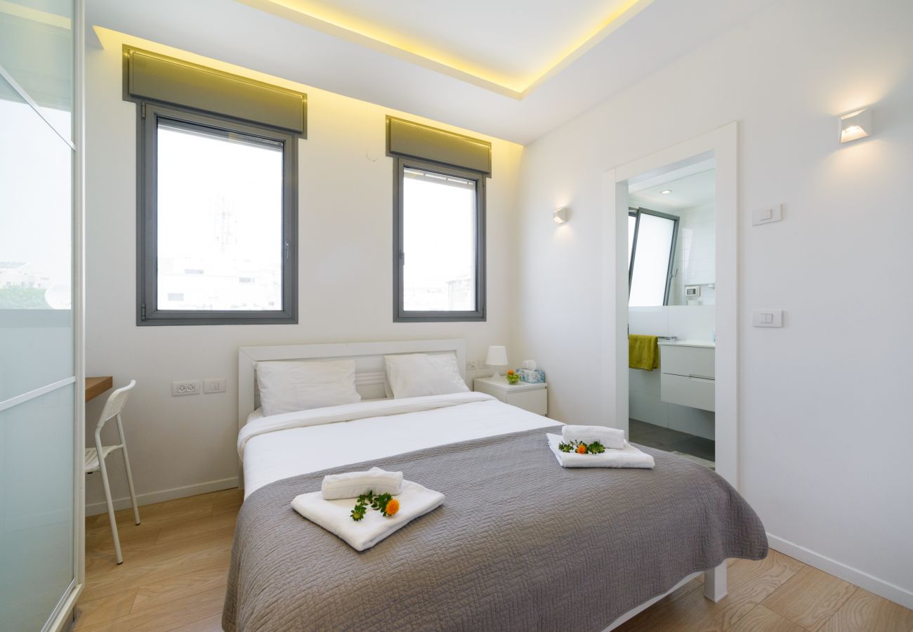Charming bedroom with big and comfy bed and a lot of light on Ben Yehuda st.