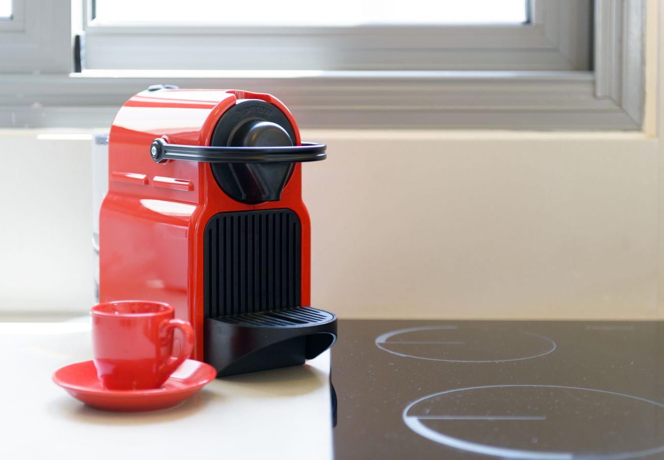 Bright red coffee machine with a red mug on Ben Yehuda st. 